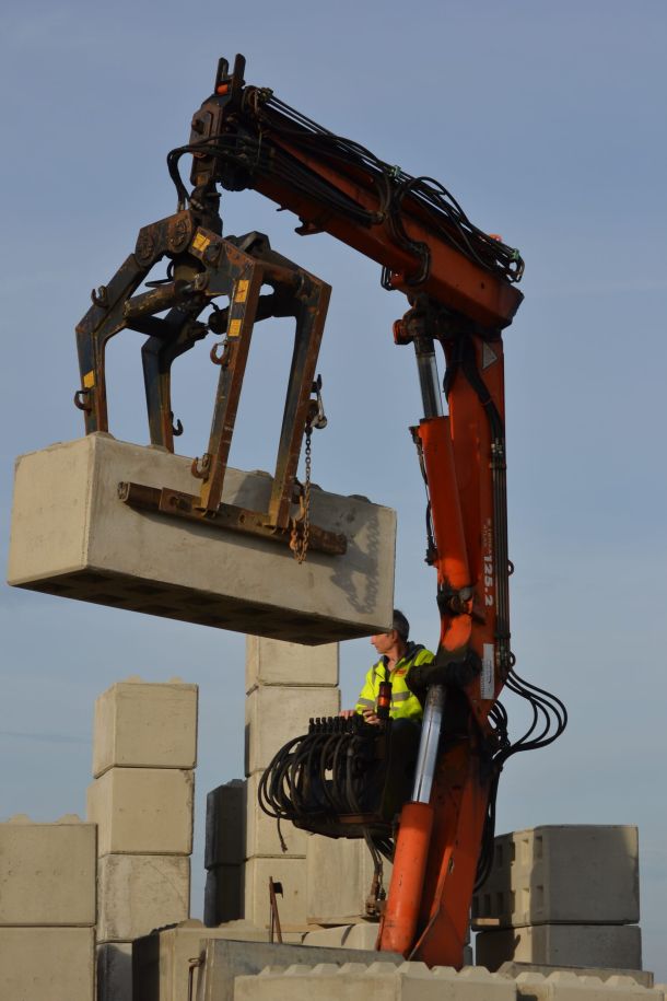 A lorry being loaded with concrete blocks